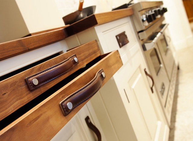Kitchen Cabinets and Drawers with Strap Leather Cabinet Pull Handles and Brass Framed Cup Handles in Chestnut